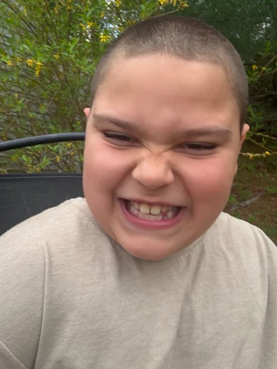 Rocco outdoors with a joyful smile